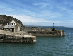Charlestown Harbour with tranquil seas and bright blue skies in mid-summer