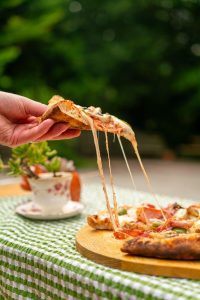 s slice of gooey sourdough pizza wood-fired and freshly made and looking good enough to eat